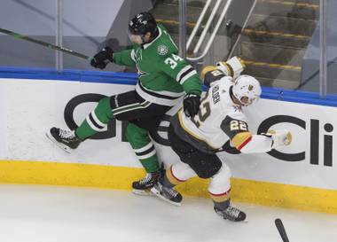 Dallas Stars right wing Denis Gurianov (34) checks Vegas Golden Knights defenceman Nick Holden (22) during the first period of Game 4 of the NHL hockey Western Conference final, Saturday, Sept. 12, 2020, in Edmonton, Alberta. (Jason Franson/The Canadian Press via AP)