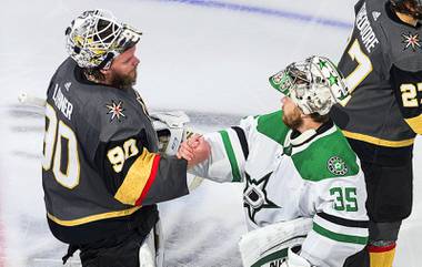 Dallas Stars goalie Anton Khudobin (35) and Vegas Golden Knights goalie Robin Lehner (90) shake hands after Dallas won during overtime NHL Western Conference final playoff game action in Edmonton, Alberta, Monday, Sept. 14, 2020.