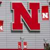 The Nebraska logo and flags incorporating the Big Ten logo are seen outside the Devaney sports center in Lincoln, Neb., Tuesday, Sept. 15, 2020. 