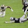 New Orleans Saints running back Alvin Kamara (41) avoids a tackle by Las Vegas Raiders defensive end Arden Key (99) during the second half of an NFL football game, Monday, Sept. 21, 2020, in Las Vegas. (AP Photo/David Becker)