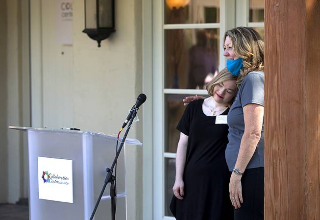 Michelle Desrochers, left, gets a hug from Lynda Tache, president and CEO of the Collaboration Center Foundation, after performing with American Sign Language during the official opening of the Collaboration Center at LV Ranch Thursday, Sept. 24, 2020. The new campus will provide support services, therapy, group classes and recreation to individuals with disabilities.
