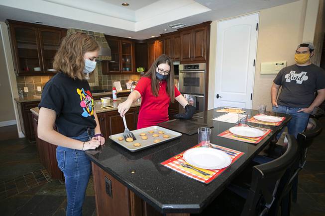 Lillie Davis, left, of Inclusion Fusion looks on as Sara Cline takes cookies from a baking pan during the official opening of the Collaboration Center at LV Ranch Thursday, Sept. 24, 2020. Mikian Musser watches at right. The new campus will provide support services, therapy, group classes and recreation to individuals with disabilities.