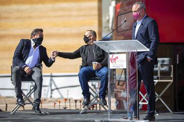 Todd English, left, owner and chef of Olives, bumps fists with Bobby Reynolds, senior vice president of AEG Presents Las Vegas, as Richard “Boz” Bosworth, president and CEO of JC Hospitality and Virgin Hotels Las Vegas, speaks during a news conference at the Virgin Hotels Las Vegas porte cochere Thursday, Sept. 24, 2020. Bosworth announced a Jan. 15, 2021 opening for the Virgin Hotels Las Vegas (formerly the Hard Rock Hotel).