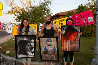 Aracely Palacio, mother of Lesly Palacio, stands with her daughters Kaly, at left, and Karely, at right, outside their home in Las Vegas, Tuesday Sept. 22, 2020. The sidewalk outside their home has become a memorial to Lesly Palacio, whose body was found in the desert near Valley of Fire State Park back on Sept. 9, 2020 after going missing for nearly 12 days. The suspects in her murder, Erick Michel Rangel-Ibarra, 25, and his father Jose Rangel, 45, are still at large.