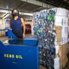 Sophia Salas Del Pozo, chief marketing officer for RENUoil of America, poses by a container of used cooking oil at the Paris Las Vegas recycling dock Friday, Sept. 25, 2020. The oil will be recycled into biodiesel fuel she said. At right is a compacted bale of PET bottles.