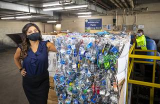 Sophia Salas-Del Pozo, chief marketing officer for RENUoil of America, poses by a compacted bale of PET bottles at the Paris Las Vegas recycling dock Friday, Sept. 25, 2020.