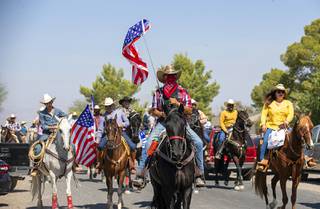 Jose Garcia flies an American flag during a parade in a residential area near Lake Mead Boulevard and Lamb Avenue Saturday, Sept. 26, 2020. Organized by State Assemblyman Edgar Flores, D-District 28, horseback riders expressed support for Democratic presidential candidate Joe Biden and their desire for an equestrian park in the northeast part of the valley.