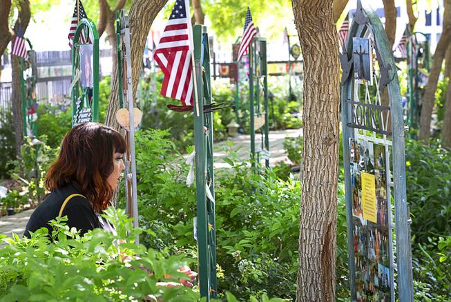Oct. 1 shooting survivor Tiffany Reardon, of Henderson, pauses to read about one of the victims of the mass shooting during a visit Saturday, Sept. 26, 2020, to the Community Healing Garden in downtown Las Vegas.