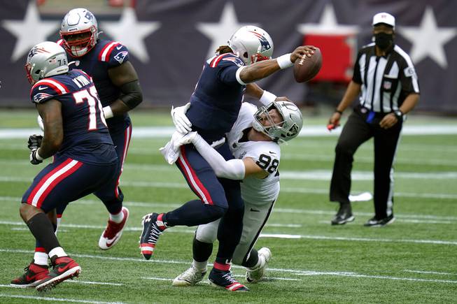 Las Vegas Raiders defensive end Maxx Crosby (98) sacks New England Patriots quarterback Cam Newton in the first half of an NFL football game, Sunday, Sept. 27, 2020, in Foxborough, Mass. 


