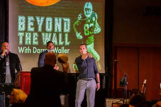 Las Vegas Raiders quarterback Derek Carr throws a signed football to a donor during the first annual 