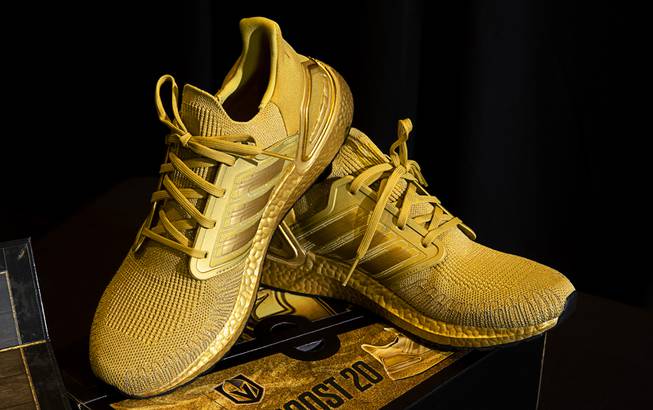 Adidas Golden Knights sneakers are displayed as the Vegas Golden Knights unveil new jerseys at City National Arena Friday, Oct. 2, 2020. The signature element is a newly developed metallic gold body fabric. There is also a "Treasure Chest" that includes the Adidas Golden Knights sneakers that is available for $777.00 at the Arsenal store at the arena