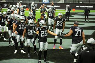 Las Vegas Raiders take to the field for warm-ups before their game against the Buffalo Bills at Allegiant Stadium Sunday, Oct. 4, 2020.