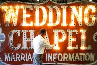 Jeffrey S. Young, Senior Vice President and Chief Marketing Officer of YESCO Custom Electric Signs, shows an in progress restoration project for the Wedding Chapel sign during a tour at the company's warehouse, Monday, Oct. 5, 2020.