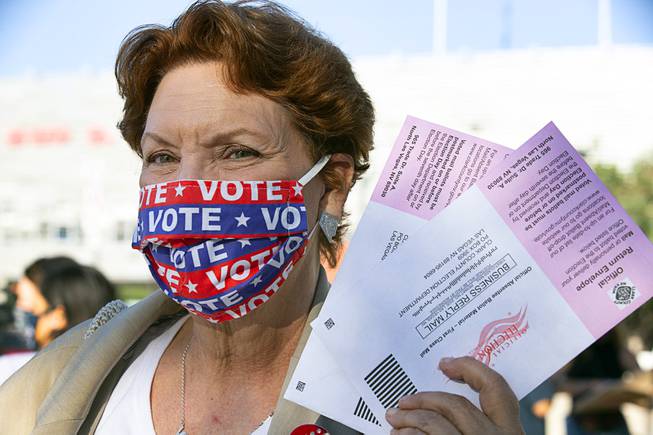 Donna West, former Clark County Democratic Party chairwoman, holds up ...