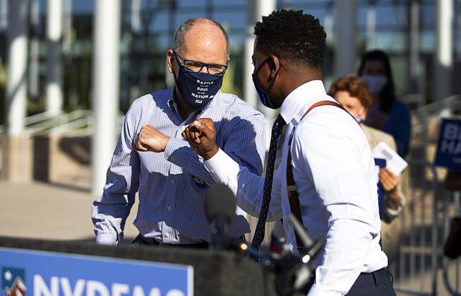 Democratic National Committee Chairman Tom Perez, left, bumps elbows with ...