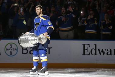 In this Oct. 2, 2019, photo, St. Louis Blues captain Alex Pietrangelo lifts the Stanley Cup during a ceremony honoring the Blues championship victory before the start of an NHL hockey game against the Washington Capitals in St. Louis.