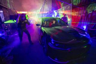 Women watch from their car during a performance at HallowheelsLV, Saturday, Oct. 17, 2020. The drive-thru 
