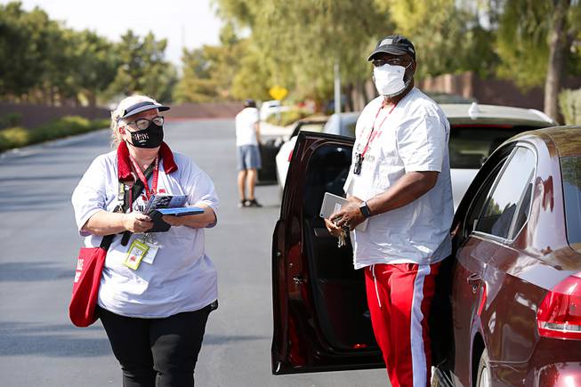 Donna Kelly-Yu, left, and Michael Washington, members of Culinary Workers Union, Local 226, canvass in a neighborhood near East Flamingo and Boulder Highway Wednesday, Oct. 21, 2020. Yu was furloughed from her casino job but got a temporary job from the union to canvas before the election.
