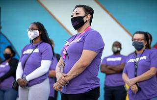 Lizette Ramirez, center, a client advocate manager at The Shade Tree shelter, listens to CEO Linda Perez during a 
