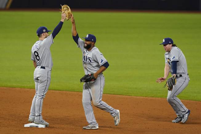 The Tampa Bay Rays celebrates their win against the Los Angeles Dodgers in Game 2 of the baseball World Series Wednesday, Oct. 21, 2020, in Arlington, Texas. Ray beat the Dodgers 6-4.