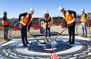 Henderson Mayor Debra March, center, poses for a ceremonial puck drop with Vegas Golden Knights' Gage Quinney, left, and Reid Duke during the celebration of a construction milestone at the Henderson Events Center construction site Wednesday, Oct. 28, 2020. The multi-purpose, 6,000-seat indoor events center will be the arena for the Henderson Silver Knights. 