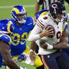 Chicago Bears quarterback Nick Foles is sacked by a group Los Angeles Rams players during their Monday Night Football game, Oct. 26, 2020 in Los Angeles.
