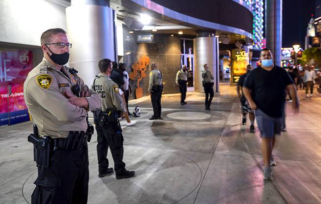 Metro Police officers take up a position outside Planet Hollywood as an officer talks with a man Saturday, Oct. 24, 2020.