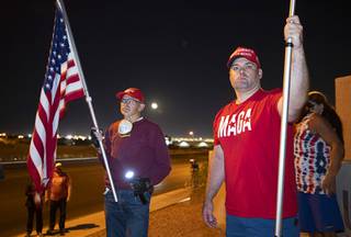 William Carpenter, left, and Lance Baker hold American flags during a 'Stop the Steal