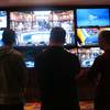 In this March 22, 2019 photo, gamblers watch live sporting events at the Hard Rock casino in Atlantic City, N.J.