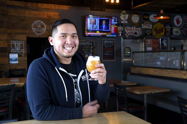 Van-Alan Nguyen, owner of 595 Craft and Kitchen and Art District Kitchen, poses with a glass of Beachwood Brewing's "Khakis & Car Keys?" IPA in 595 Craft at Rainbow Boulevard and Tropicana Avenue Wednesday, Nov. 11, 2020.