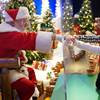 Julianna, 3, and Dylan, 5, Lasczak visit with Santa through a transparent barrier at a Bass Pro Shop in Bridgeport, Conn., Tuesday, Nov. 10, 2020.