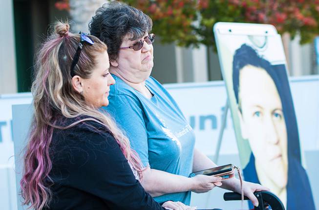 Angelena Moore and Judy Booth stand near a photo of Eduardo Clemente, 38, during a news conference at Metro Police headquarters, Thursday, Nov. 19, 2020. Clemente is wanted on a murder warrant in the death of his girlfriend, Tiffany Booth, whose body was found near Indian Springs on Oct. 19, 2020.