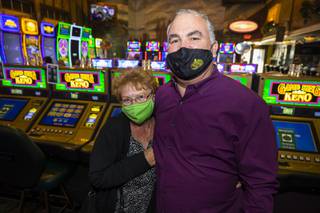 Regular customer Sandy Pelz poses for a photo with Emerald Island Casino owner Tim Brooks inside his casino in Henderson, Tuesday, Nov. 17, 2020.