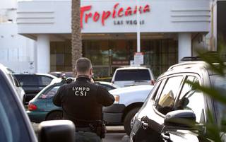 A Metro Police crime scene analyst takes photos after a shooting in the parking lot of the Tropicana hotel-casino Saturday, Nov. 21, 2020. The shooting was apparently related to a drug deal, police said.