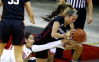 UNLV Lady Rebels guard Jacinta Buckley (10) and Stanford Cardinal guard Lexie Hull (12) chase after a loose ball during a game at the Thomas & Mack Center Saturday, Dec. 5, 2020.