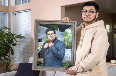 Adam Mendoza holds a photo of his father, Eddie Mendoza, in Henderson Tuesday, Dec. 8, 2020. Eddie Mendoza, a Station Casino employee, died of COVID-19 in September at age 37.