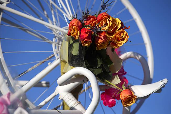 Roses adorn a Ghost Bike memorial during a vigil at at Las Vegas Cyclery Saturday, Dec. 12, 2020. Five cyclists were killed in an accident on U.S. 95 near Searchlight on Thursday.