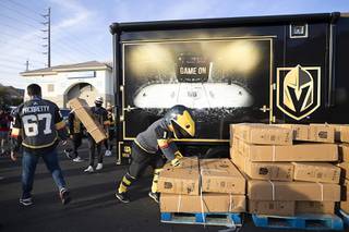 Vegas Golden Knights mascot Chance the Golden Gila Monster helps unload bicycles at HELP of Southern Nevada Tuesday, Dec. 15, 2020. The Vegas Golden Knights Foundation donated 50 Golden Knights-themed bicycles and $25,000 to HELP of Southern Nevada.