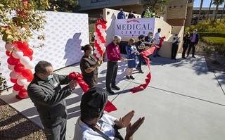 Employees cut a ceremonial ribbon during the opening of a free health clinic for Station Casinos employees and their families at Red Rock Resort Tuesday, Dec. 15, 2020. A similar clinic opened at Sunset Station in Henderson.