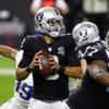 Las Vegas Raiders quarterback Marcus Mariota (8) looks for a receiver during the first half of a game against the Los Angeles Chargers at Allegiant Stadium Thursday, Dec. 17, 2020.