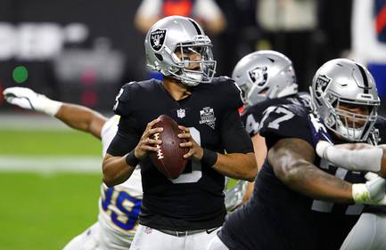 Las Vegas Raiders quarterback Marcus Mariota (8) looks for a receiver during the first half of a game against the Los Angeles Chargers at Allegiant Stadium Thursday, Dec. 17, 2020.