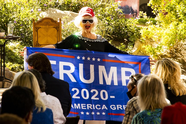 An attendee holds up a Trump 2020 flag prior to ...