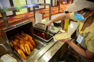 Dharmi Patel assembles a Vienna Beef Chicago hot dog at a cart inside the South Point Hotel and Casino Wed. Jan 6, 2021.