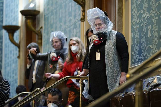 People are seen in the House gallery as protesters try ...