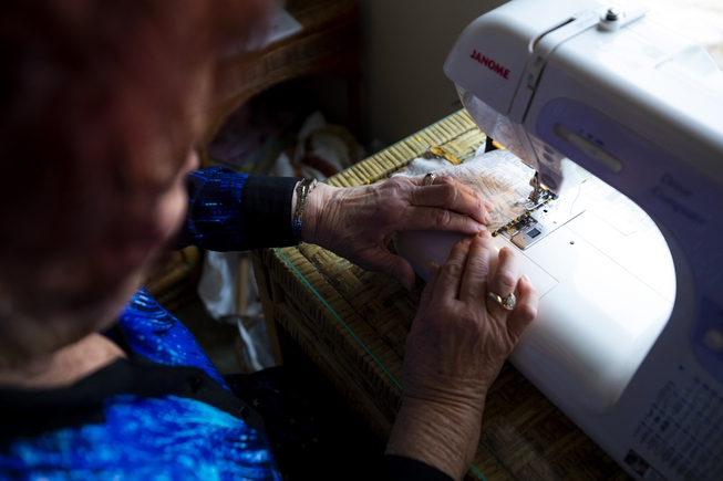 Sharon Royer, 77, sews a face mask in her home, ...