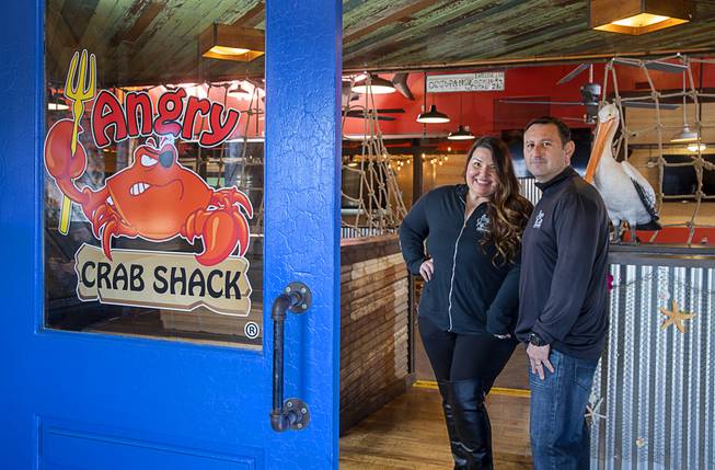 Owners Dana and Rick Lopez pose in the Angry Crab ...
