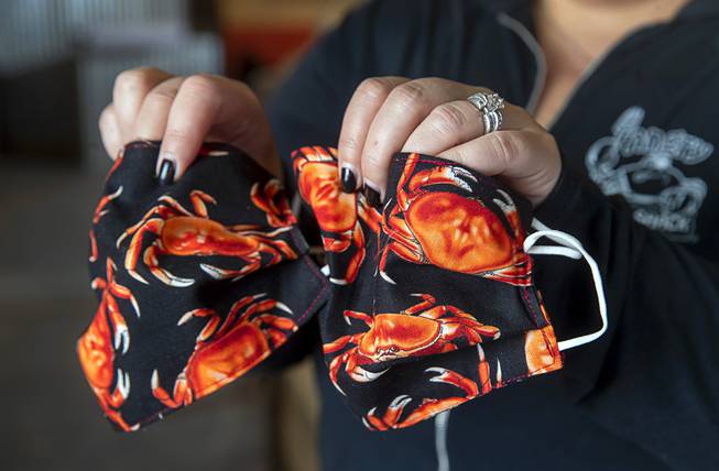 Owner Dana Lopez displays crab-themed face masks in the Angry ...