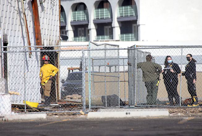 Investigators gather by a building at 1431 Las Vegas Blvd. ...