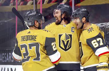 Vegas Golden Knights defenseman Shea Theodore (27), right wing Mark Stone and left wing Max Pacioretty (67) celebrate after Pacioretty’s overtime goal against the Anaheim Ducks in an NHL hockey game Saturday, Jan. 16, 2021, in Las Vegas.