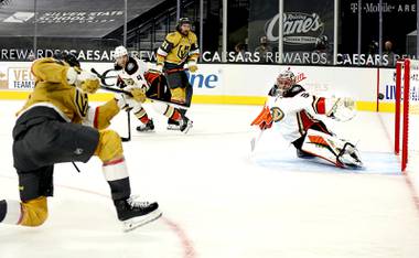 Vegas Golden Knights left wing Max Pacioretty, left, shoots and scores past Anaheim Ducks goalie John Gibson (36) during overtime in an NHL hockey game Saturday, Jan. 16, 2021, in Las Vegas.